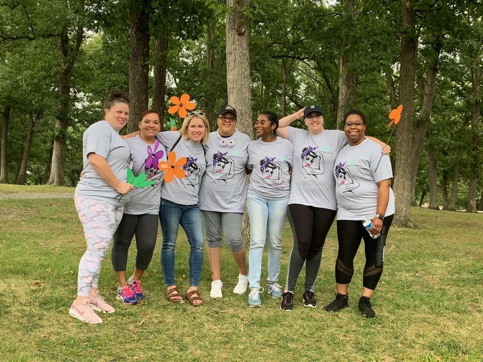 Seniorlink employees smiling at an Alzheimer's fundraising walk 